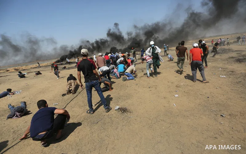 Palestinian protesters gather during clashes with Israeli troops in a protest marking al-Quds Day, (Jerusalem Day), at the Israel-Gaza border in Khan Younis in the southern Gaza Strip on June 8, 2018. Photo by Ashraf Amr...
