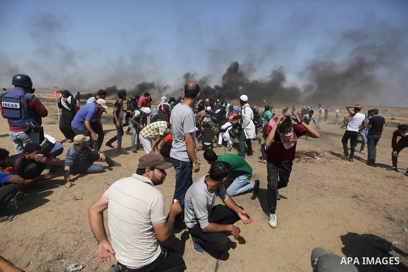 Palestinian protesters gather during clashes with Israeli troops in a protest marking al-Quds Day, (Jerusalem Day), at the Israel-Gaza border in Khan Younis in the southern Gaza Strip on June 8, 2018. Photo by Ashraf Amr...