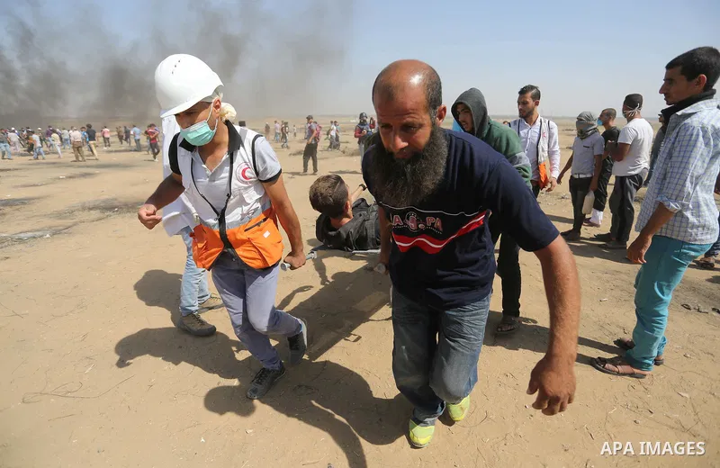 A wounded Palestinian protester is evacuated during clashes with Israeli security froces in a protest marking al-Quds Day, (Jerusalem Day), at the Israel-Gaza border in Khan Younis in the southern Gaza Strip on June 8, 2...