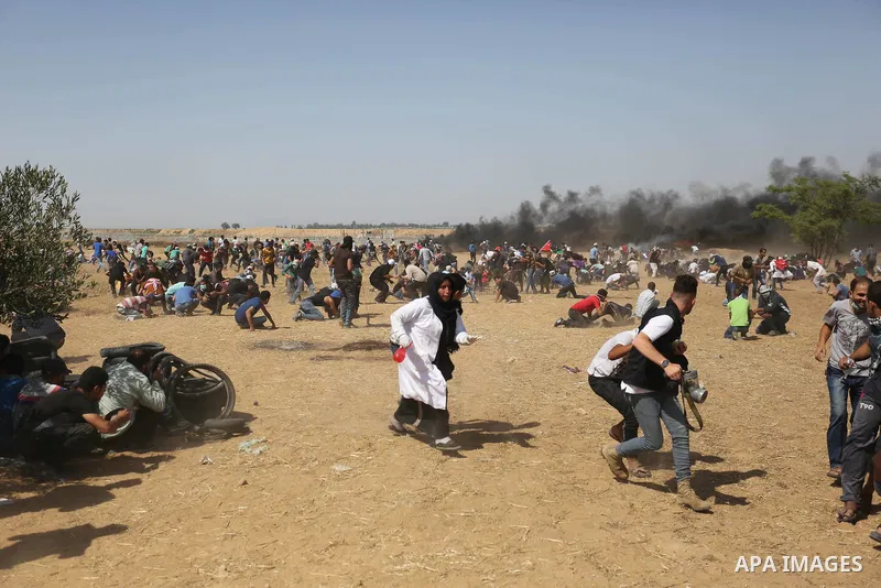 Palestinian protesters gather during clashes with Israeli troops in a protest marking al-Quds Day, (Jerusalem Day), at the Israel-Gaza border in Khan Younis in the southern Gaza Strip on June 8, 2018. Photo by Ashraf Amr...