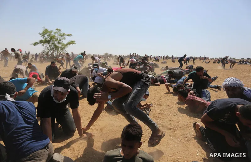 Palestinian protesters gather during clashes with Israeli troops in a protest marking al-Quds Day, (Jerusalem Day), at the Israel-Gaza border in Khan Younis in the southern Gaza Strip on June 8, 2018. Photo by Ashraf Amr...