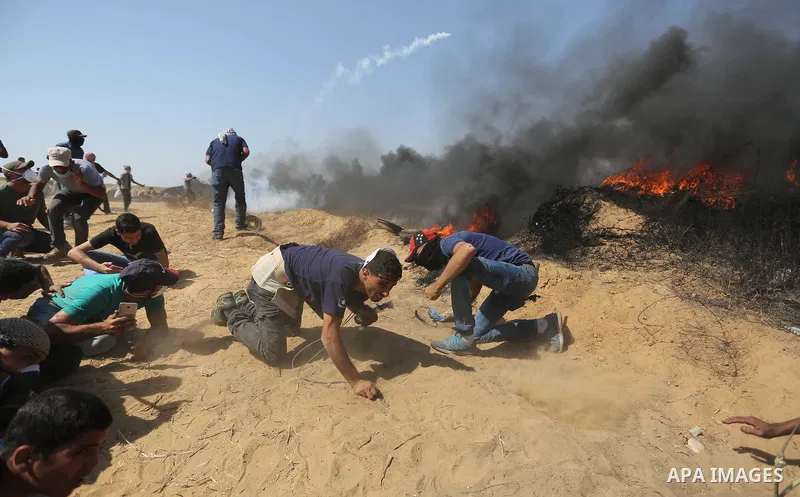 Palestinian protesters gather during clashes with Israeli troops in a protest marking al-Quds Day, (Jerusalem Day), at the Israel-Gaza border in Khan Younis in the southern Gaza Strip on June 8, 2018. Photo by Ashraf Amr...