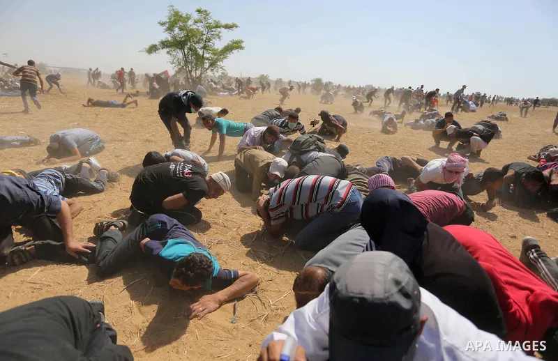 Palestinian protesters gather during clashes with Israeli troops in a protest marking al-Quds Day, (Jerusalem Day), at the Israel-Gaza border in Khan Younis in the southern Gaza Strip on June 8, 2018. Photo by Ashraf Amr...