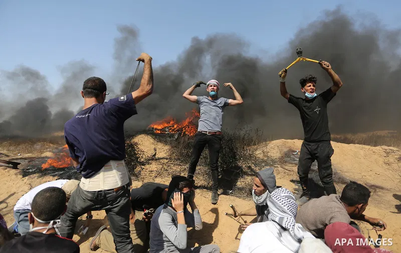 Palestinian protesters gather during clashes with Israeli troops in a protest marking al-Quds Day, (Jerusalem Day), at the Israel-Gaza border in Khan Younis in the southern Gaza Strip on June 8, 2018. Photo by Ashraf Amr...