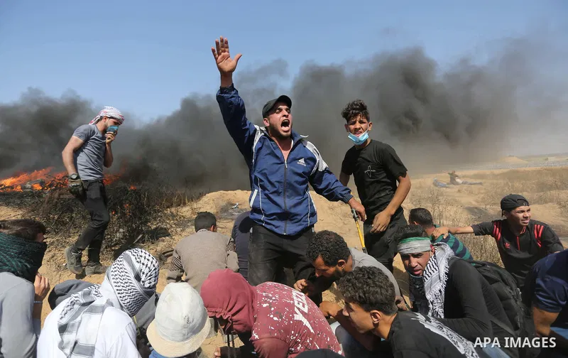 Palestinian protesters gather during clashes with Israeli troops in a protest marking al-Quds Day, (Jerusalem Day), at the Israel-Gaza border in Khan Younis in the southern Gaza Strip on June 8, 2018. Photo by Ashraf Amr...