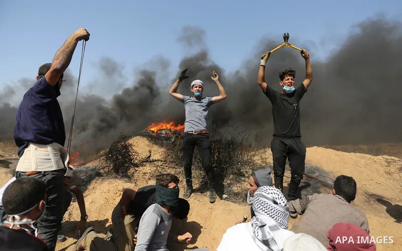 Palestinian protesters gather during clashes with Israeli troops in a protest marking al-Quds Day, (Jerusalem Day), at the Israel-Gaza border in Khan Younis in the southern Gaza Strip on June 8, 2018. Photo by Ashraf Amr...