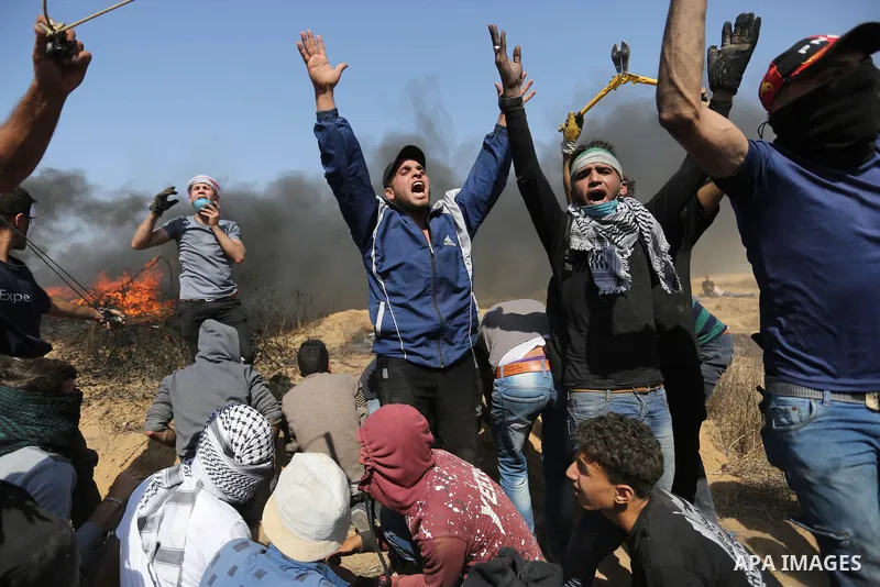 Palestinian protesters gather during clashes with Israeli troops in a protest marking al-Quds Day, (Jerusalem Day), at the Israel-Gaza border in Khan Younis in the southern Gaza Strip on June 8, 2018. Photo by Ashraf Amr...