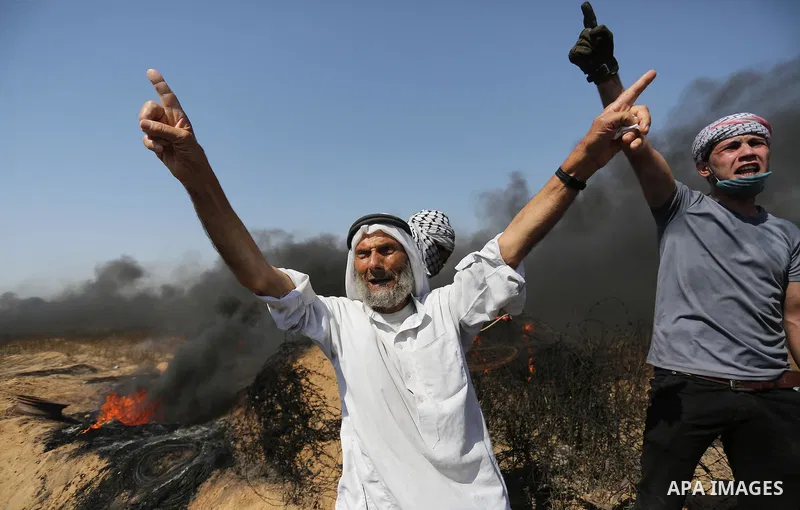 Palestinian protesters gather during clashes with Israeli troops in a protest marking al-Quds Day, (Jerusalem Day), at the Israel-Gaza border in Khan Younis in the southern Gaza Strip on June 8, 2018. Photo by Ashraf Amr...