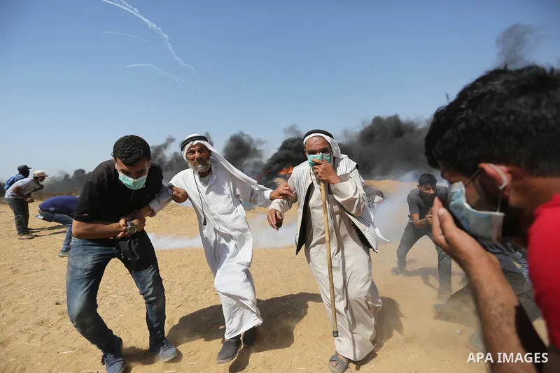 Palestinian protesters gather during clashes with Israeli troops in a protest marking al-Quds Day, (Jerusalem Day), at the Israel-Gaza border in Khan Younis in the southern Gaza Strip on June 8, 2018. Photo by Ashraf Amr...