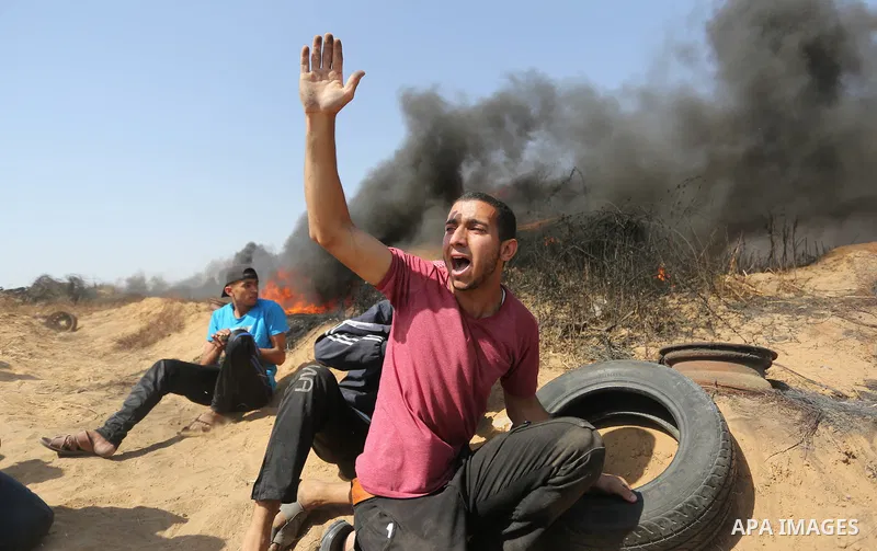 Palestinian protesters gather during clashes with Israeli troops in a protest marking al-Quds Day, (Jerusalem Day), at the Israel-Gaza border in Khan Younis in the southern Gaza Strip on June 8, 2018. Photo by Ashraf Amr...