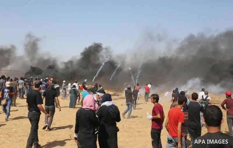 Palestinian protesters gather during clashes with Israeli troops in a protest marking al-Quds Day, (Jerusalem Day), at the Israel-Gaza border in Khan Younis in the southern Gaza Strip on June 8, 2018. Photo by Ashraf Amr...