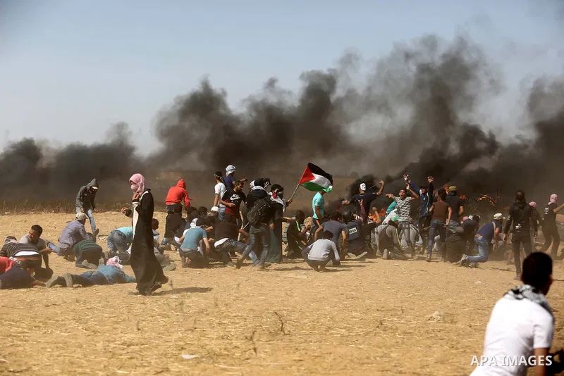 Palestinian protesters gather during clashes with Israeli troops in a protest marking al-Quds Day, (Jerusalem Day), at the Israel-Gaza border in Khan Younis in the southern Gaza Strip on June 8, 2018. Photo by Ashraf Amr...