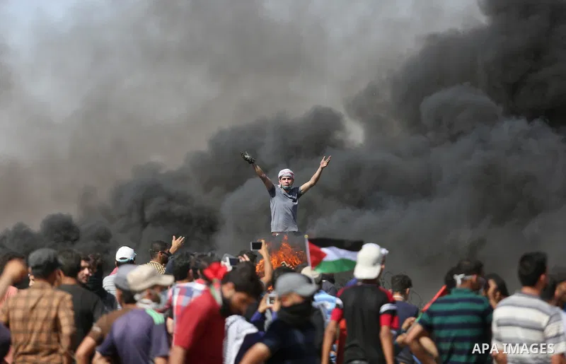 Palestinian protesters gather during clashes with Israeli troops in a protest marking al-Quds Day, (Jerusalem Day), at the Israel-Gaza border in Khan Younis in the southern Gaza Strip on June 8, 2018. Photo by Ashraf Amr...
