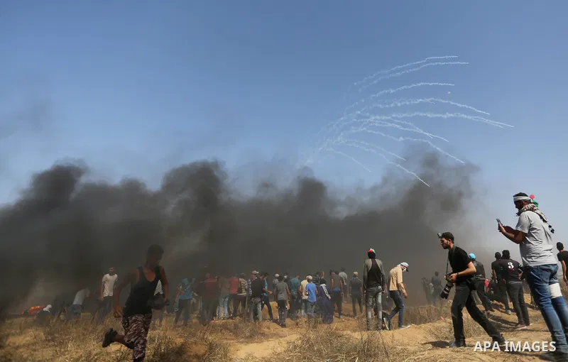 Palestinian protesters gather during clashes with Israeli troops in a protest marking al-Quds Day, (Jerusalem Day), at the Israel-Gaza border in Khan Younis in the southern Gaza Strip on June 8, 2018. Photo by Ashraf Amr...