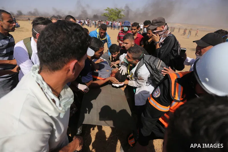 A wounded Palestinian protester is evacuated during clashes with Israeli security froces in a protest marking al-Quds Day, (Jerusalem Day), at the Israel-Gaza border in Khan Younis in the southern Gaza Strip on June 8, 2...