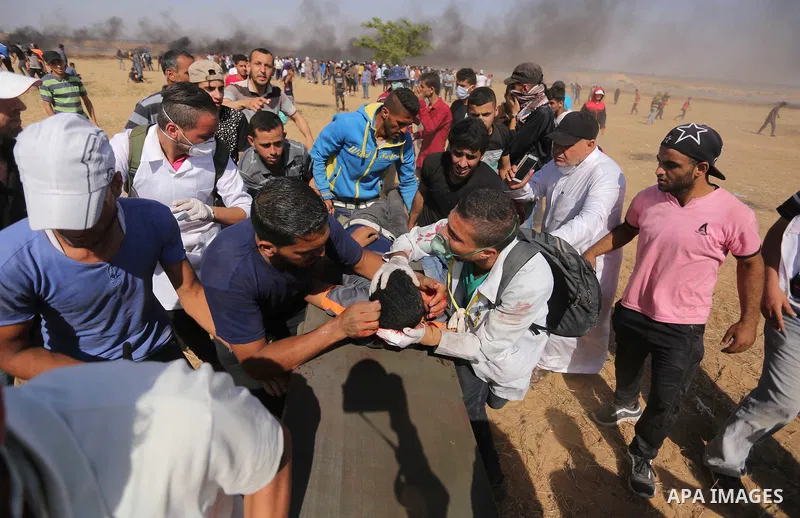 A wounded Palestinian protester is evacuated during clashes with Israeli security froces in a protest marking al-Quds Day, (Jerusalem Day), at the Israel-Gaza border in Khan Younis in the southern Gaza Strip on June 8, 2...