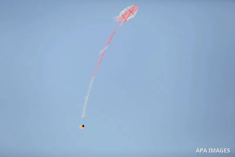 A kite laden with a molotov cocktail being flown by Palestinian protesters over the border with Israel before cutting the string across the fence, durin in a protest marking al-Quds Day, (Jerusalem Day), at the Israel-Ga...