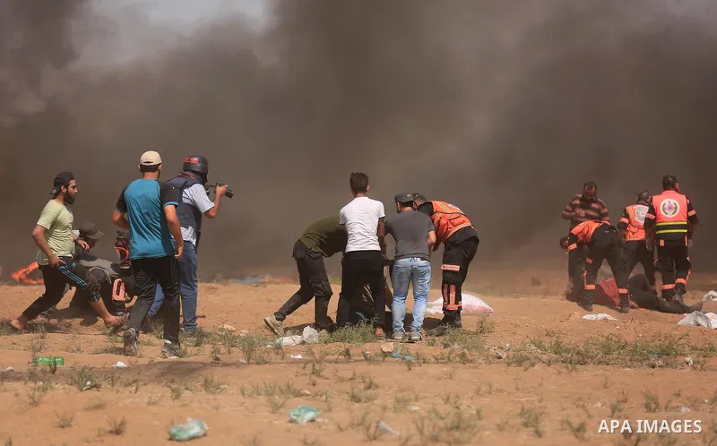 Palestinian protesters gather during clashes with Israeli troops in a protest marking al-Quds Day, (Jerusalem Day), at the Israel-Gaza border in east of Gaza city, on June 8, 2018. Photo by Dawoud Abo Alkas