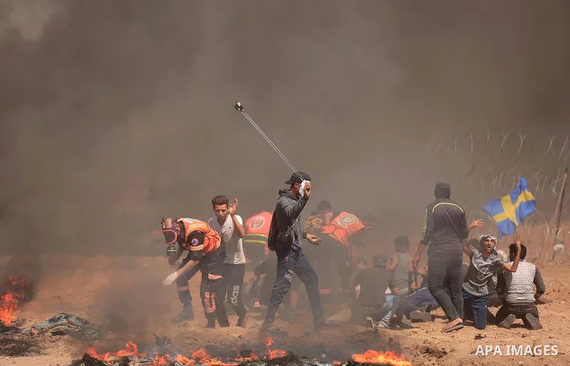 Palestinian protesters gather during clashes with Israeli troops in a protest marking al-Quds Day, (Jerusalem Day), at the Israel-Gaza border in east of Gaza city, on June 8, 2018. Photo by Dawoud Abo Alkas