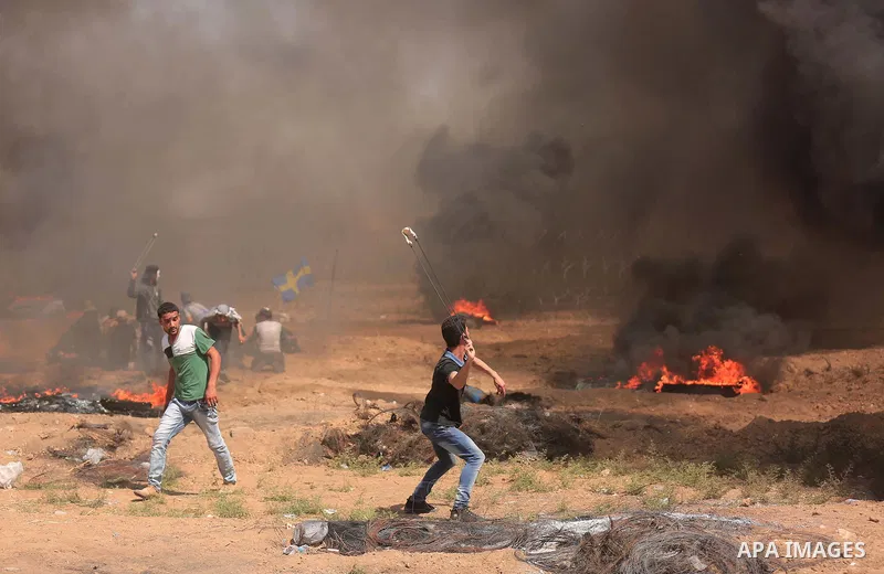Palestinian protesters gather during clashes with Israeli troops in a protest marking al-Quds Day, (Jerusalem Day), at the Israel-Gaza border in east of Gaza city, on June 8, 2018. Photo by Dawoud Abo Alkas