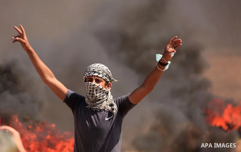 Palestinian protesters gather during clashes with Israeli troops in a protest marking al-Quds Day, (Jerusalem Day), at the Israel-Gaza border in east of Gaza city, on June 8, 2018. Photo by Dawoud Abo Alkas