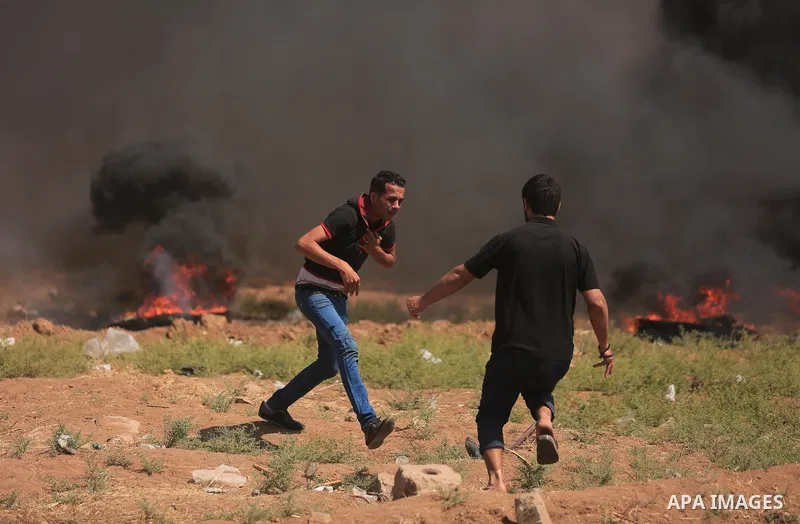 Palestinian protesters gather during clashes with Israeli troops in a protest marking al-Quds Day, (Jerusalem Day), at the Israel-Gaza border in east of Gaza city, on June 8, 2018. Photo by Dawoud Abo Alkas