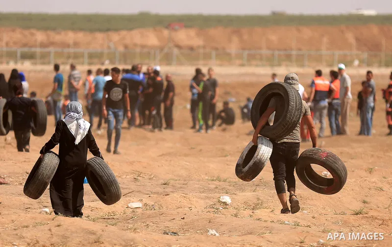 Palestinian protesters gather during clashes with Israeli troops in a protest marking al-Quds Day, (Jerusalem Day), at the Israel-Gaza border in east of Gaza city, on June 8, 2018. Photo by Dawoud Abo Alkas