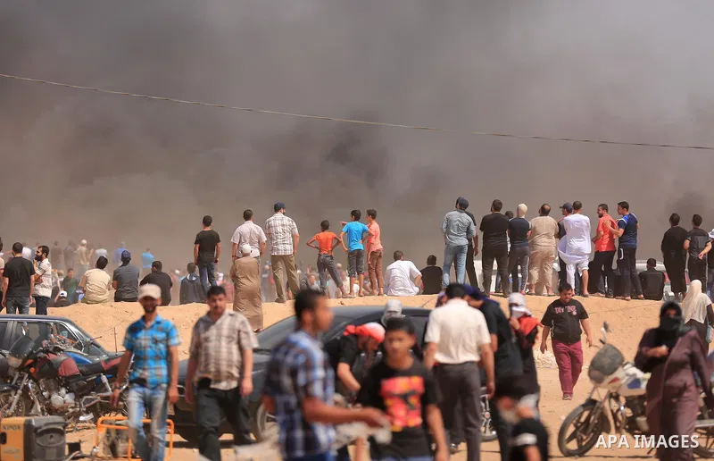 Palestinian protesters gather during clashes with Israeli troops in a protest marking al-Quds Day, (Jerusalem Day), at the Israel-Gaza border in east of Gaza city, on June 8, 2018. Photo by Dawoud Abo Alkas
