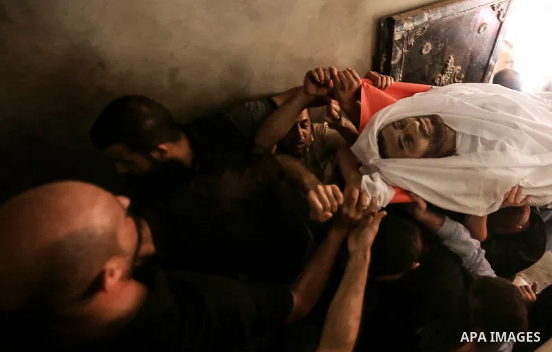 Palestinian relatives carry the body of Yussef al-Faseeh, 29, who was shot dead by Israeli troops during clashes at Israel-Gaza border, during his funeral in Gaza city on on 9, 2018. Four Palestinians were killed by Isra...