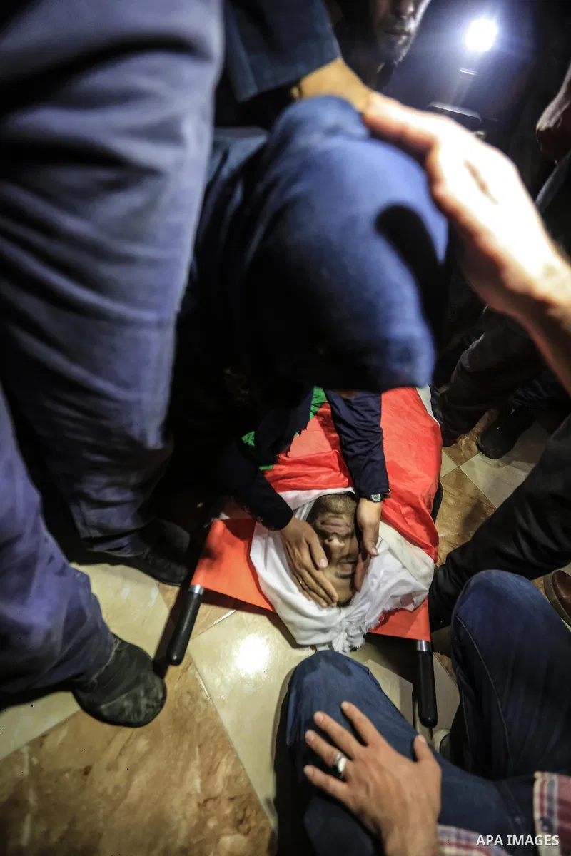 Palestinian relatives mourn over the body of Yussef al-Faseeh, 29, who was shot dead by Israeli troops during clashes at Israel-Gaza border, during his funeral in Gaza city on on 9, 2018. Four Palestinians were killed by...
