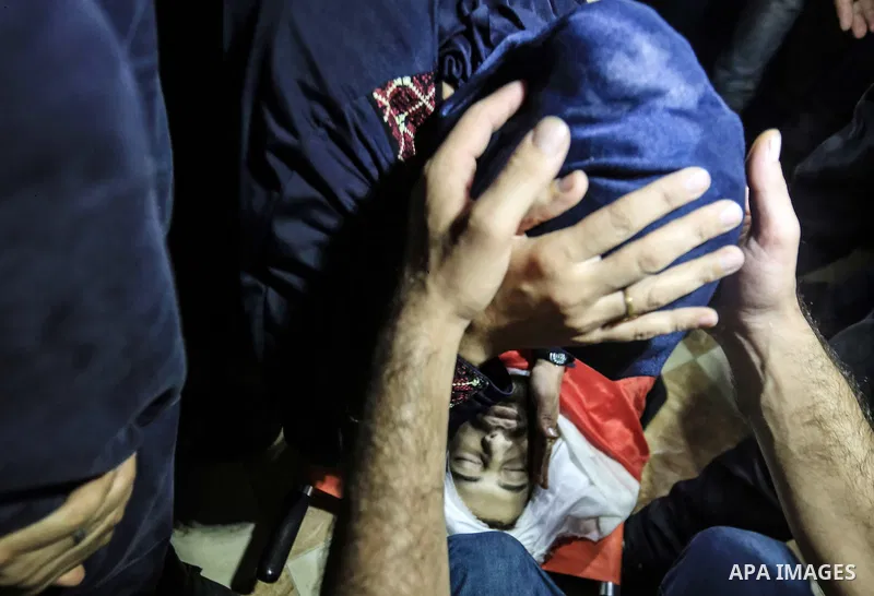 Palestinian relatives mourn over the body of Yussef al-Faseeh, 29, who was shot dead by Israeli troops during clashes at Israel-Gaza border, during his funeral in Gaza city on on 9, 2018. Four Palestinians were killed by...