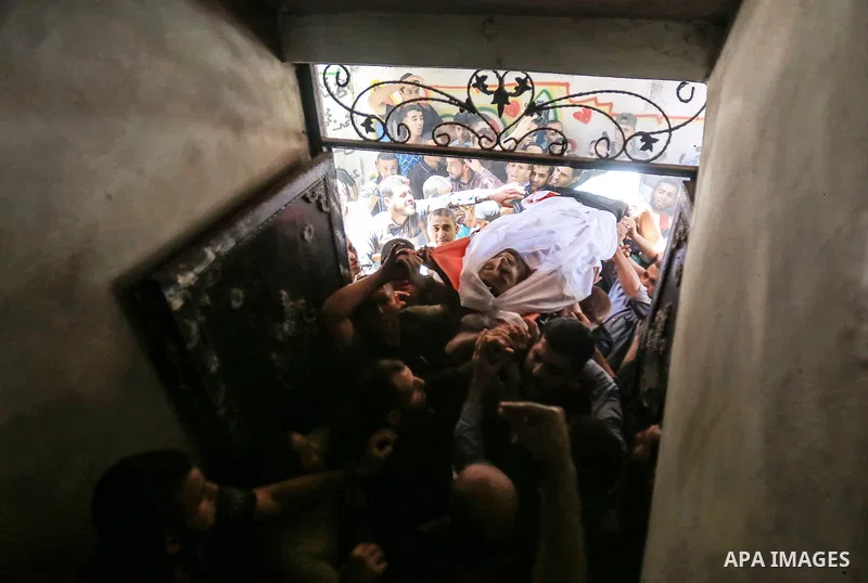 Palestinian relatives carry the body of Yussef al-Faseeh, 29, who was shot dead by Israeli troops during clashes at Israel-Gaza border, during his funeral in Gaza city on on 9, 2018. Four Palestinians were killed by Isra...