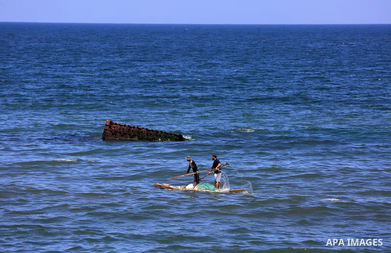 Palestinian fishermen ride their fishing boat off the coast of Gaza City on June 9, 2018. Photo by Dawoud Abo Alkas