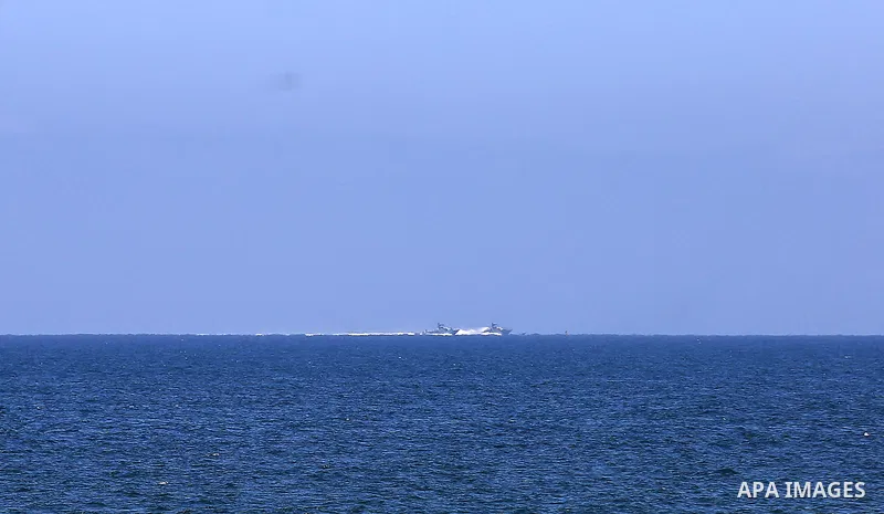 A picture taken on June 9, 2018 shows Israeli naval ships patrol off the coast of Gaza City. Photo by Dawoud Abo Alkas