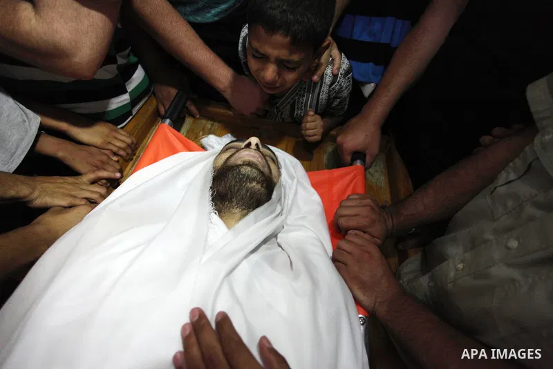 Palestinian relatives mourn over the body of Yussef al-Faseeh, 29, who was shot dead by Israeli troops during clashes at Israel-Gaza border, during his funeral in Gaza city on on 9, 2018. Four Palestinians were killed by...