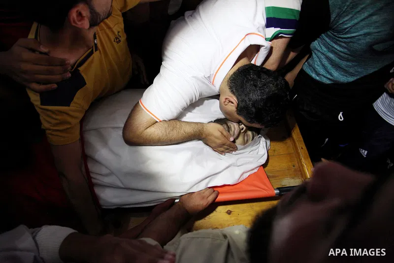 Palestinian relatives mourn over the body of Yussef al-Faseeh, 29, who was shot dead by Israeli troops during clashes at Israel-Gaza border, during his funeral in Gaza city on on 9, 2018. Four Palestinians were killed by...