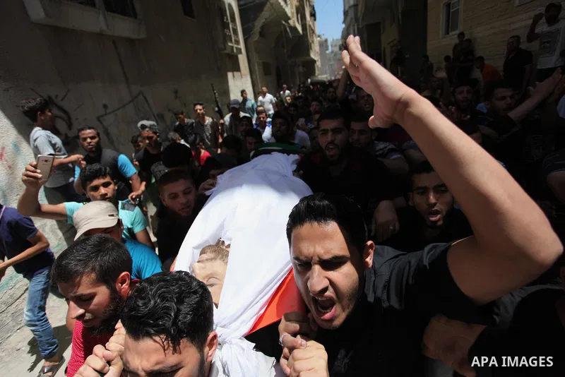 Palestinian relatives carry the body of Yussef al-Faseeh, 29, who was shot dead by Israeli troops during clashes at Israel-Gaza border, during his funeral in Gaza city on on 9, 2018. Four Palestinians were killed by Isra...