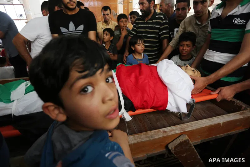 Palestinian relatives mourn over the body of Ziad al-Barim, 25, who was shot dead by Israeli troops during clashes at Israel-Gaza border, during his funeral in Khan Younis in the southern Gaza strip on June 9, 2018. Four...