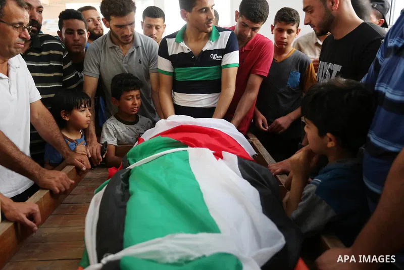 Palestinian relatives mourn over the body of Ziad al-Barim, 25, who was shot dead by Israeli troops during clashes at Israel-Gaza border, during his funeral in Khan Younis in the southern Gaza strip on June 9, 2018. Four...