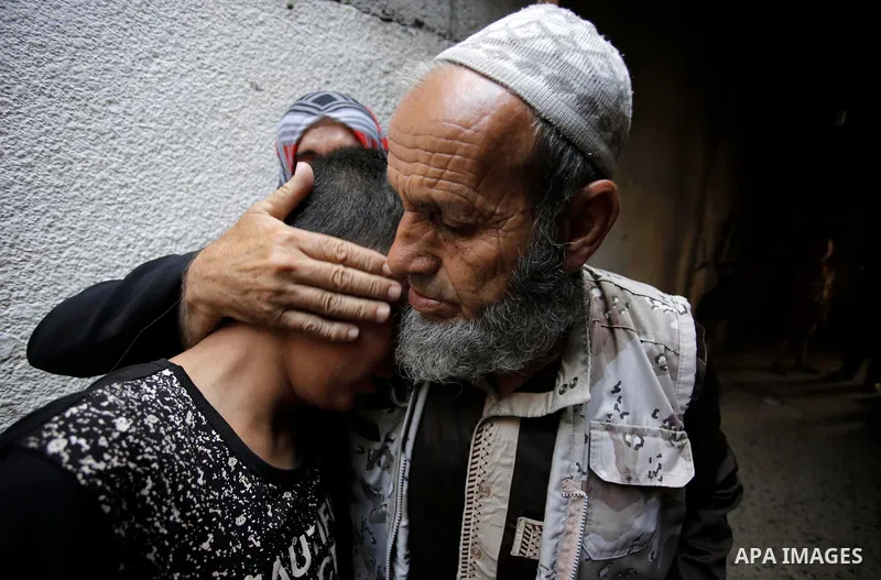 Relatives of Palestinian Haitham al-Jamal, 15, who was shot dead by Israeli troops during clashes, mourn during his funeral in Rafah in the southern Gaza Strip on June 9, 2018. Four Palestinians were killed by Israeli fi...