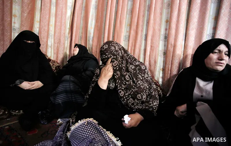 Relatives of Palestinian Haitham al-Jamal, 15, who was shot dead by Israeli troops during clashes, mourn during his funeral in Rafah in the southern Gaza Strip on June 9, 2018. Four Palestinians were killed by Israeli fi...