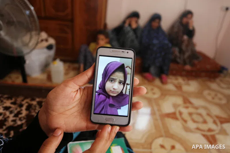 The mother of Palestinian Wesal Sheikh Khalil, 15, who was shot dead by Israeli troops during clashes at Israel-Gaza border holds a mobile phone and showing the picture of her daughter at their home at al-Maghazi camp in...