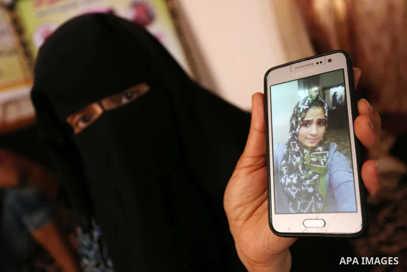 The mother of Palestinian Wesal Sheikh Khalil, 15, who was shot dead by Israeli troops during clashes at Israel-Gaza border holds a mobile phone and showing the picture of her daughter at their home at al-Maghazi camp in...