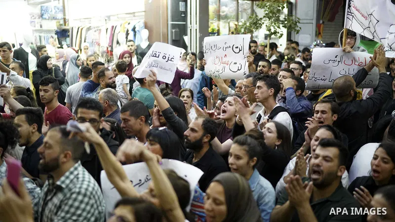 Palestinians take part in a protest demanding to lift the sanctions on Gaza Strip, in the West Bank city of Ramallah, on June 10, 2018. Photo by Eyad Jadallah