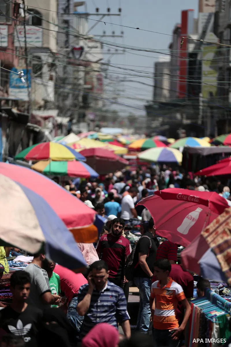Palestinians shop at a market a few days ahead of Eid al-Fitr holiday in Gaza city on June 11, 2018. Eid al-Fitr marks the end of Muslim's holy fasting month of Ramadan when faithfuls abstain from eating, drinking, smoki...