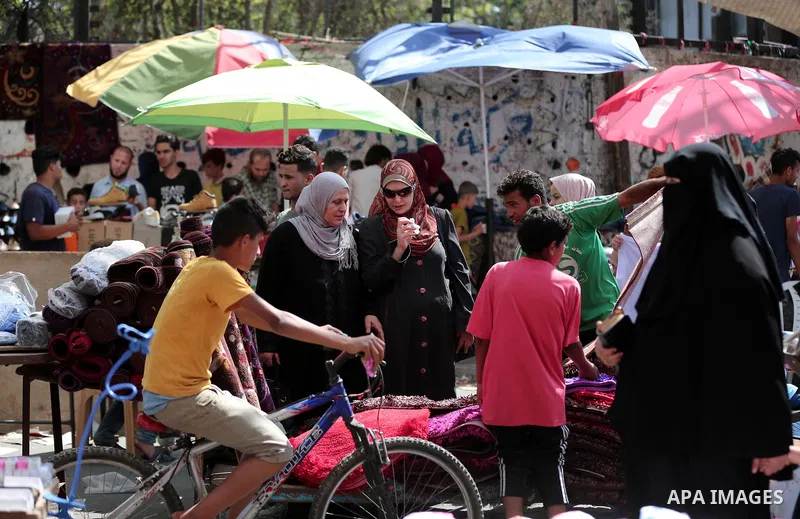 Palestinians shop at a market a few days ahead of Eid al-Fitr holiday in Gaza city on June 11, 2018. Eid al-Fitr marks the end of Muslim's holy fasting month of Ramadan when faithfuls abstain from eating, drinking, smoki...