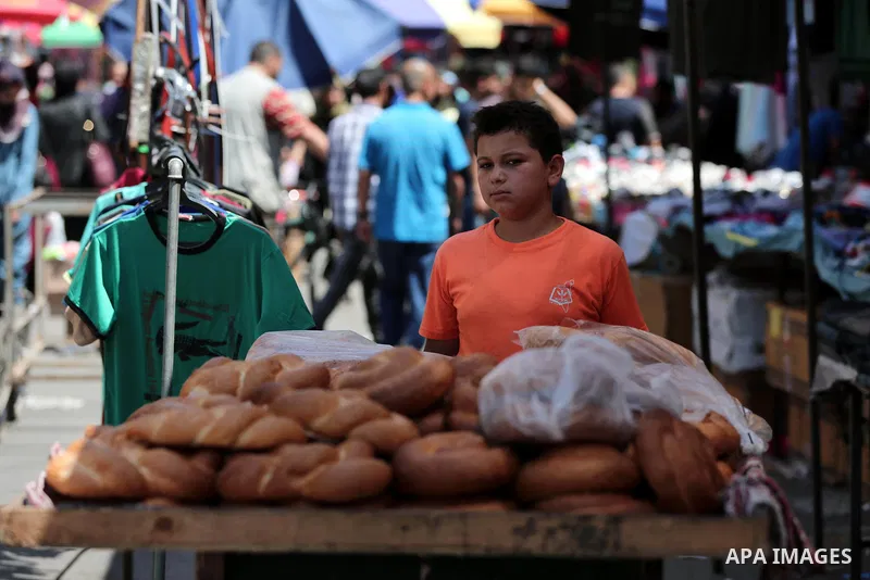 Palestinians shop at a market a few days ahead of Eid al-Fitr holiday in Gaza city on June 11, 2018. Eid al-Fitr marks the end of Muslim's holy fasting month of Ramadan when faithfuls abstain from eating, drinking, smoki...
