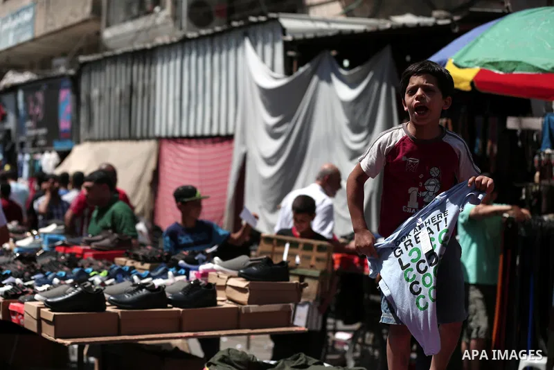 Palestinians shop at a market a few days ahead of Eid al-Fitr holiday in Gaza city on June 11, 2018. Eid al-Fitr marks the end of Muslim's holy fasting month of Ramadan when faithfuls abstain from eating, drinking, smoki...