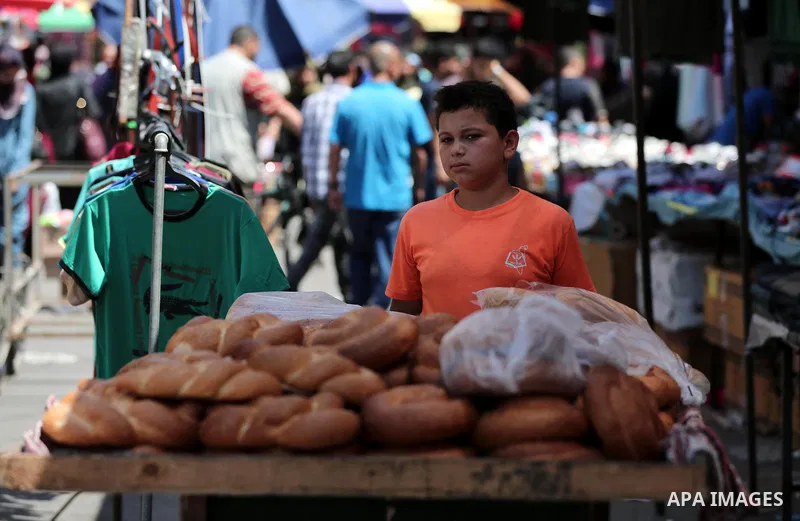Palestinians shop at a market a few days ahead of Eid al-Fitr holiday in Gaza city on June 11, 2018. Eid al-Fitr marks the end of Muslim's holy fasting month of Ramadan when faithfuls abstain from eating, drinking, smoki...
