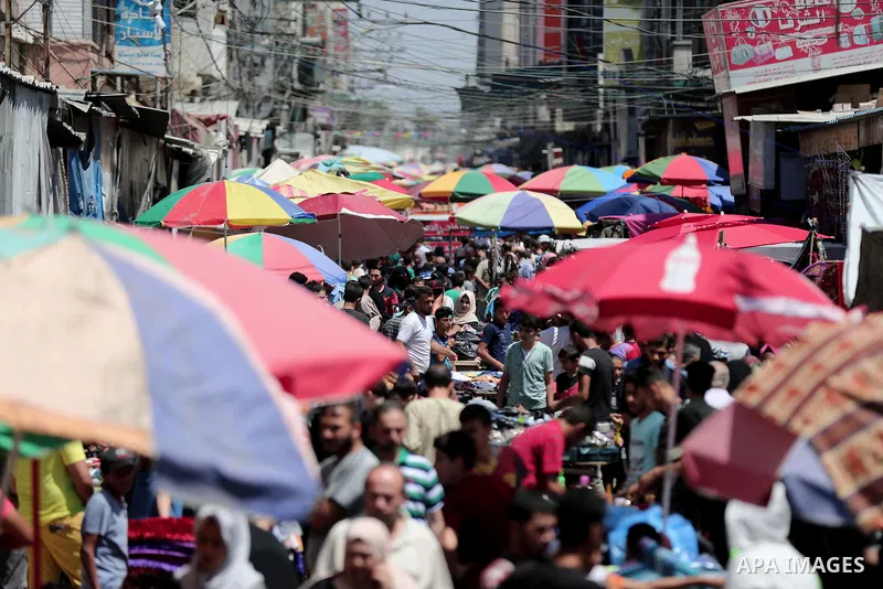 Palestinians shop at a market a few days ahead of Eid al-Fitr holiday in Gaza city on June 11, 2018. Eid al-Fitr marks the end of Muslim's holy fasting month of Ramadan when faithfuls abstain from eating, drinking, smoki...